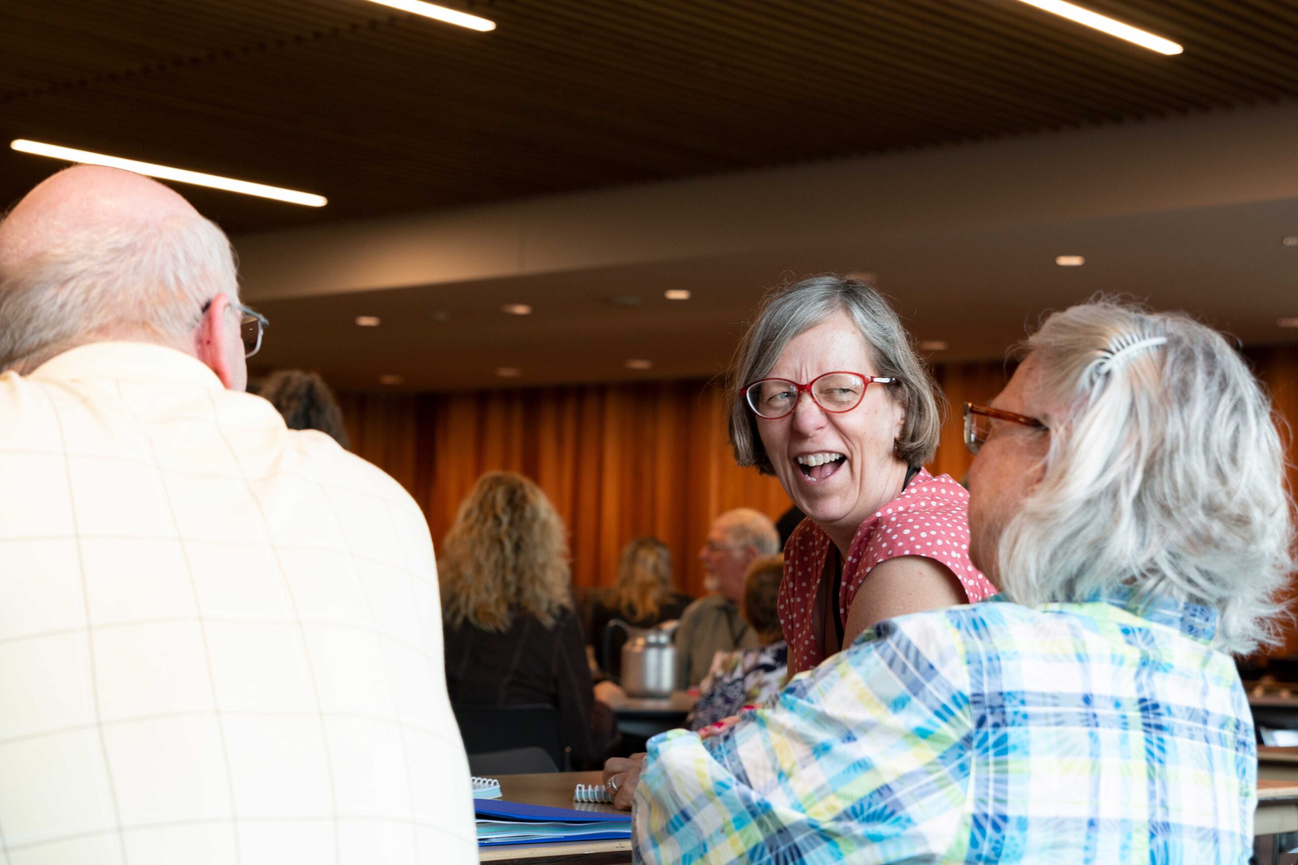 People laugh at a meeting during Joint Annual Meeting 2019